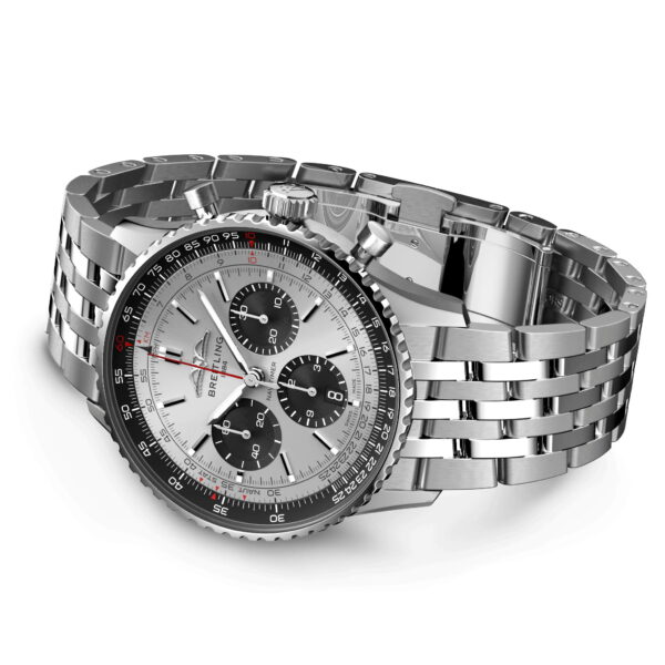 Eine luxuriöse silberne Armbanduhr mit Gliederarmband und weißem Zifferblatt mit drei schwarzen Hilfszifferblättern. Die Lünette ist schwarz mit Tachymetermarkierungen. Der Markenname der Uhr ist auf dem Zifferblatt sichtbar.