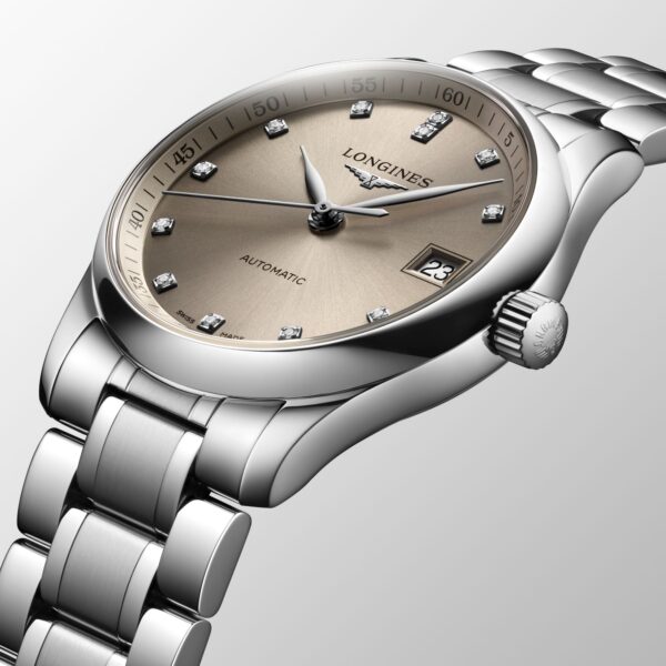 Eine silberne Luxusarmbanduhr mit beigem Zifferblatt mit Diamant-Stundenmarkierungen, einem kleinen Datumsfenster auf der 3-Uhr-Position und deutlich sichtbarem Markennamen. Die Uhr hat ein metallisches Gliederarmband.