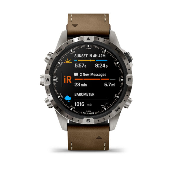 Die Garmin Marq Adventurer 2.Gen Smartwatch verfügt über ein rundes Zifferblatt, das Uhrzeit, Nachrichtenbenachrichtigungen, Sonnenuntergangszeiten, Infrarotdaten, Barometerwerte und einen Kompass auf der Lünette anzeigt. Sie wird mit einem braunen Lederarmband und einem Metallgehäuse geliefert.
