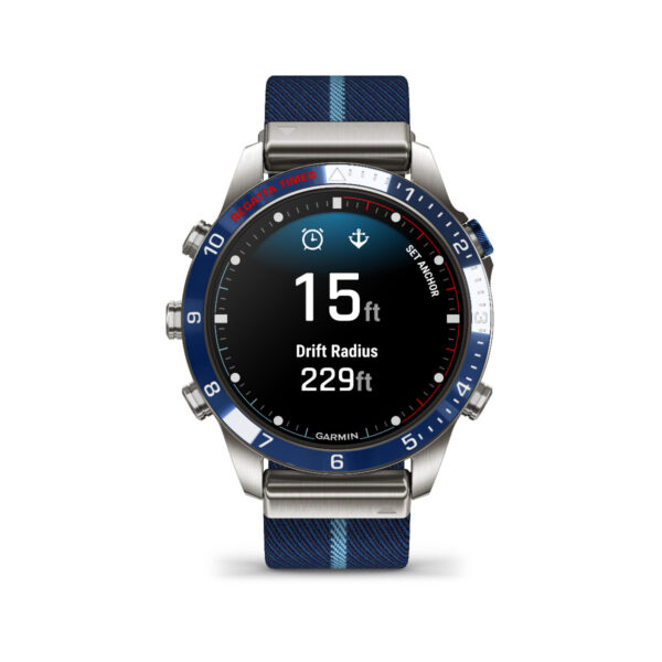 Die Smartwatch Garmin Marq Captain 2.Gen. verfügt über ein blau-silbernes Design, zeigt einen Driftradius von 15 Fuß und eine Tiefe von 229 Fuß auf dem Bildschirm an, hat drei seitliche Tasten und ist mit einem blau gestreiften Armband ausgestattet.