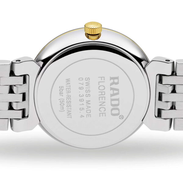 Die Rückseite der Rado Florence Classic Armbanduhr zeigt ein silbernes Gehäuse mit einer goldenen Krone, die mit den Gravuren „RADO“, „FLORENCE“, „SWISS MADE“ und Angaben zur Wasserdichtigkeit versehen ist. Das Armband ist mit silbernen Metallgliedern versehen.
