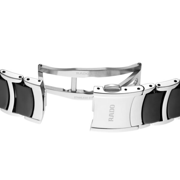 Nahaufnahme eines Rado Centrix Diamonds-Uhrenarmbands mit einer Faltschließe aus Edelstahl und schwarzen Keramikgliedern, teilweise geöffnet, um den detaillierten Schließmechanismus und die in das Metall eingravierte Aufschrift „RADO“ freizugeben.