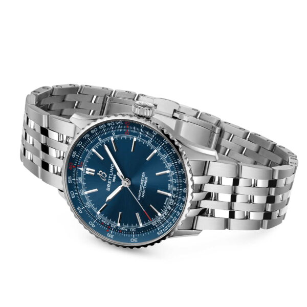 Die Breitling Navitimer Automatic 41 verfügt über ein silbernes Gehäuse, ein blaues Zifferblatt, silberne Indexe und ein Gliederarmband aus Edelstahl, das schräg auf einem weißen Hintergrund präsentiert wird.