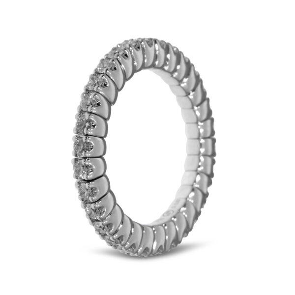 Der Scheffel Stretch Coronet Damenring ist ein silberner Ewigkeitsring mit einem geriffelten Design und kleinen funkelnden Diamanten auf der oberen Hälfte, die auf weißem Hintergrund abgebildet sind.