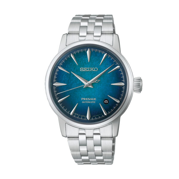 Eine Seiko Presage Cocktail Time Automatik-Armbanduhr mit einem strukturierten blauen Zifferblatt, silbernen Indexen und Zeigern, einem Datumsfenster bei 3 Uhr und einem Edelstahlarmband.